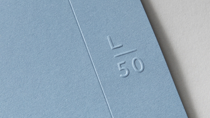 Latitude50's shortened 'L 50' logo, embossed on card.