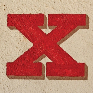 The letter X painted on stone.