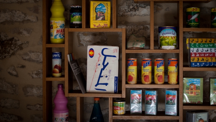 A selection of branded products from around the world displayed on a bookshelf.
