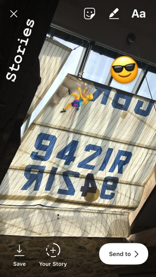 An image of a yacht-sail curtain being posted on Instagram stories, with emojis overlaid.