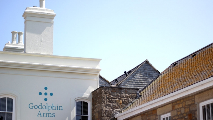 The Godolphin Arms, with its logo on the side of the building.