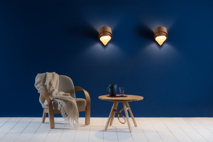 Tom Raffield products: an armchair, a table and two wall-mounted lights.