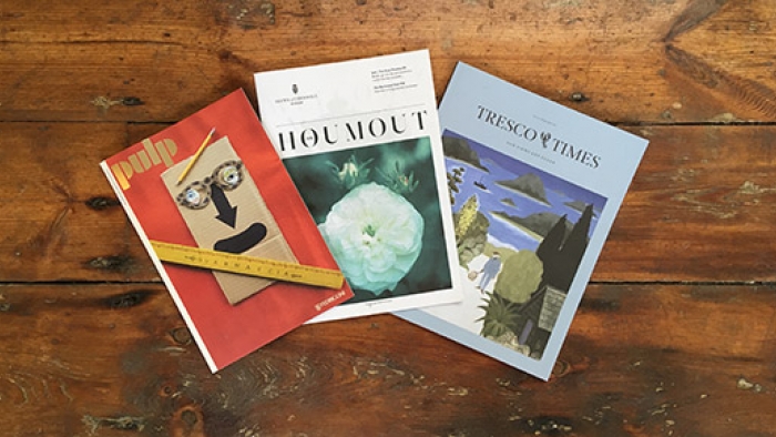 Three brand magazines – titled Pulp, Houmout and Tresco Times – spread out on a wooden floor.