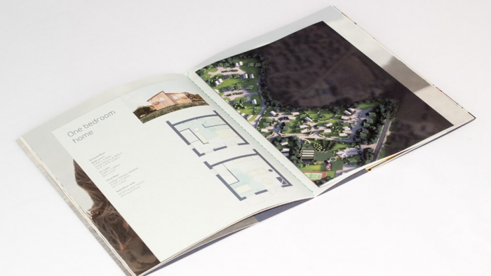 A spread from the Una St Ives brochure with a property floor plan and an aerial image of a Cornish village.